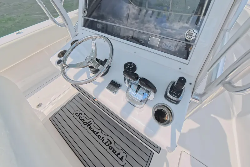 Slide: The Image of 2019 SeaHunter 33 Tournament boat helm with steering wheel and controls. - 24