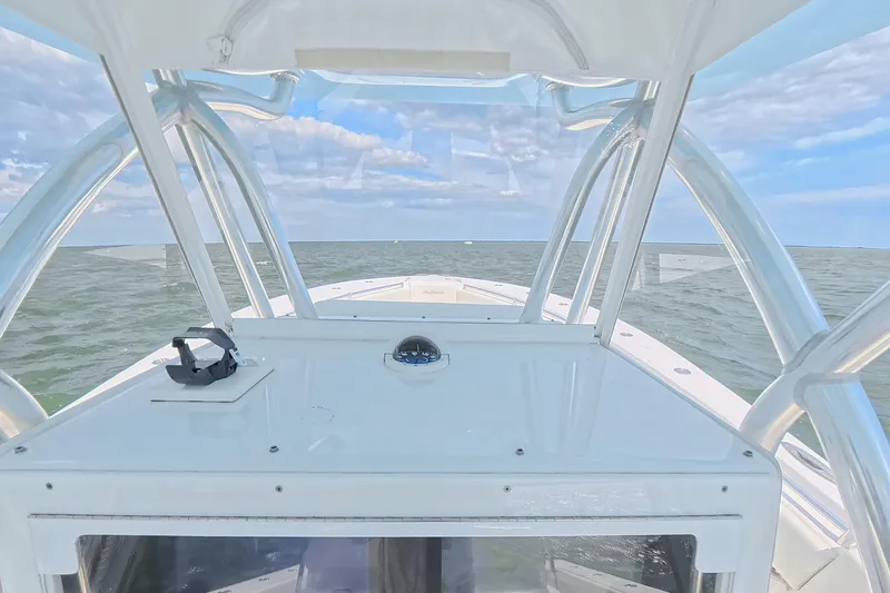 Slide: The Image of 2019 SeaHunter 33 Tournament boat dashboard view on open water under blue sky. - 25