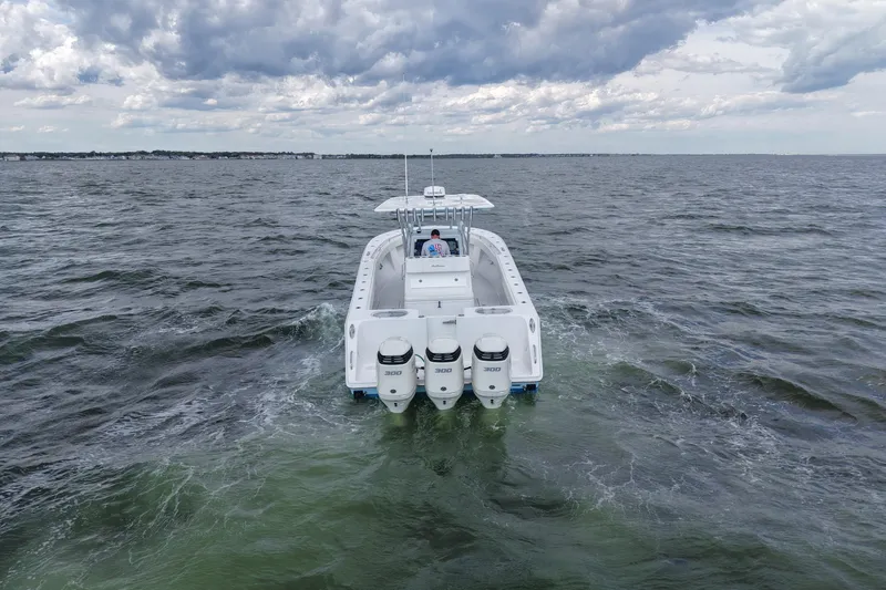 Slide: The Image of 2019 SeaHunter 33 Tournament boat cruising on open water under cloudy skies. - 3