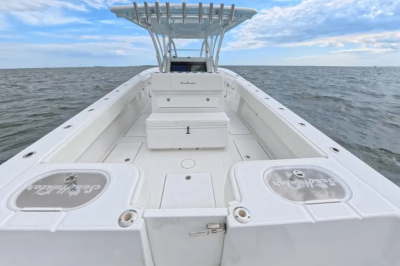 Slide: The Image of 2019 SeaHunter 33 Tournament boat on open water, showcasing spacious deck and seating. - 30