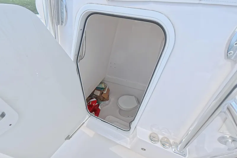 Slide: The Image of 2019 SeaHunter 33 Tournament boat interior with open storage compartment and visible toilet. - 34