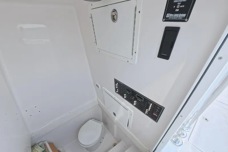 Slide: The Image of Interior of 2019 SeaHunter 33 Tournament boat featuring a compact marine toilet. - 35