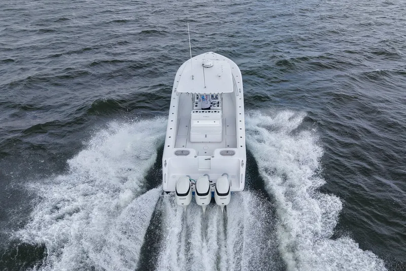 Slide: The Image of 2019 SeaHunter 33 Tournament boat cruising on open water, aerial view. - 39