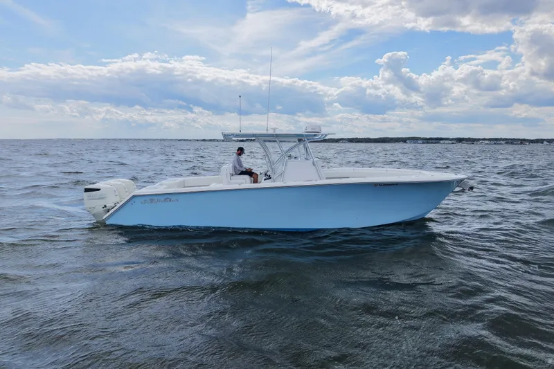 Slide: The Image of 2019 SeaHunter 33 Tournament boat on open water under a partly cloudy sky. - 5