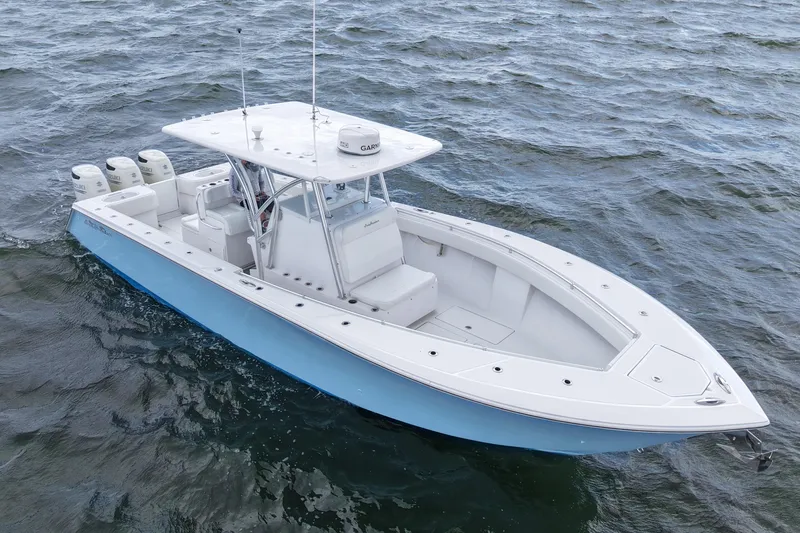 Slide: The Image of 2019 SeaHunter 33 Tournament boat on open water, featuring sleek design and multiple engines. - 8