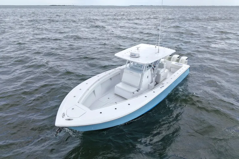 Slide: The Image of 2019 SeaHunter 33 Tournament boat on open water, showcasing sleek design and powerful engines. - 9