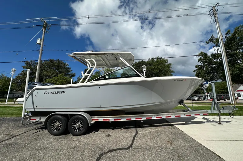 The Image of 2021 Sailfish 276 DC boat on trailer under blue sky with clouds. - 0