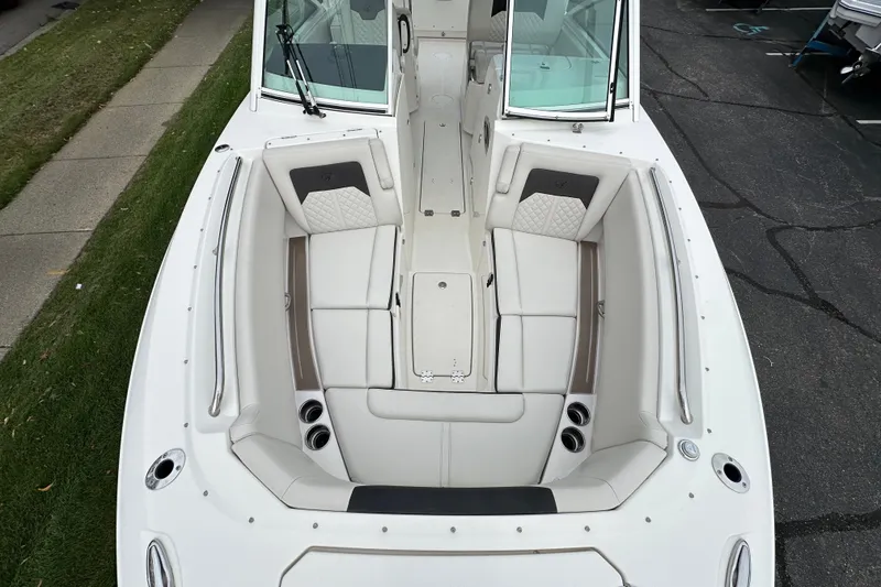 Slide: The Image of 2021 Sailfish 276 DC boat interior with white seating and cup holders. - 12