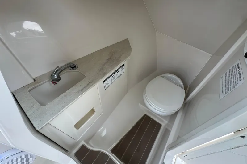 Slide: The Image of 2021 Sailfish 276 DC boat bathroom with sink and toilet. - 13