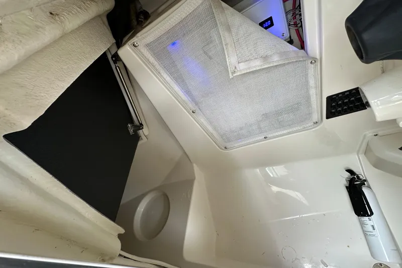 Slide: The Image of Interior view of 2021 Sailfish 276 DC boat, featuring storage and safety equipment. - 14