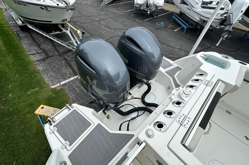 Slide: The Image of 2021 Sailfish 276 DC boat with dual Yamaha outboard motors, docked on a trailer. - 2