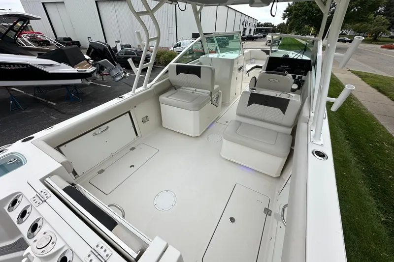 Slide: The Image of 2021 Sailfish 276 DC boat interior with seating and control panel, docked outdoors. - 3