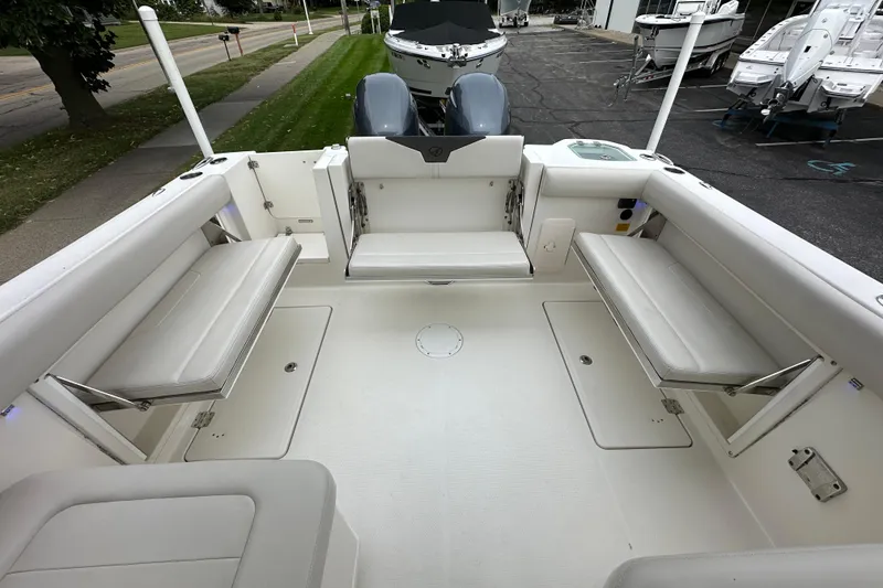 Slide: The Image of 2021 Sailfish 276 DC boat interior with cushioned seating and spacious deck. - 4