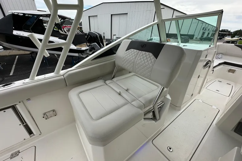 Slide: The Image of 2021 Sailfish 276 DC boat interior with white seating and modern design. - 7