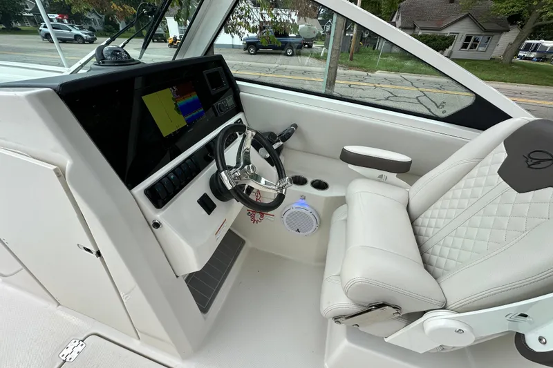 Slide: The Image of 2021 Sailfish 276 DC boat cockpit with steering wheel and navigation display. - 9