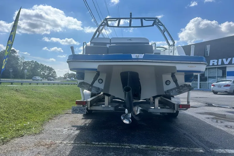 Slide: The Image of 2020 Monterey M4 boat on trailer, parked outdoors under a blue sky. - 2