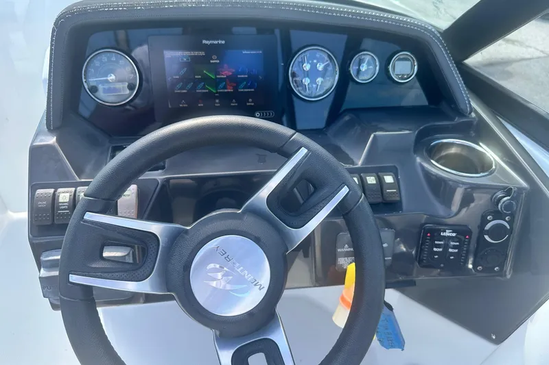 Slide: The Image of Steering wheel and dashboard of a 2020 Monterey M4 boat with navigation display. - 27