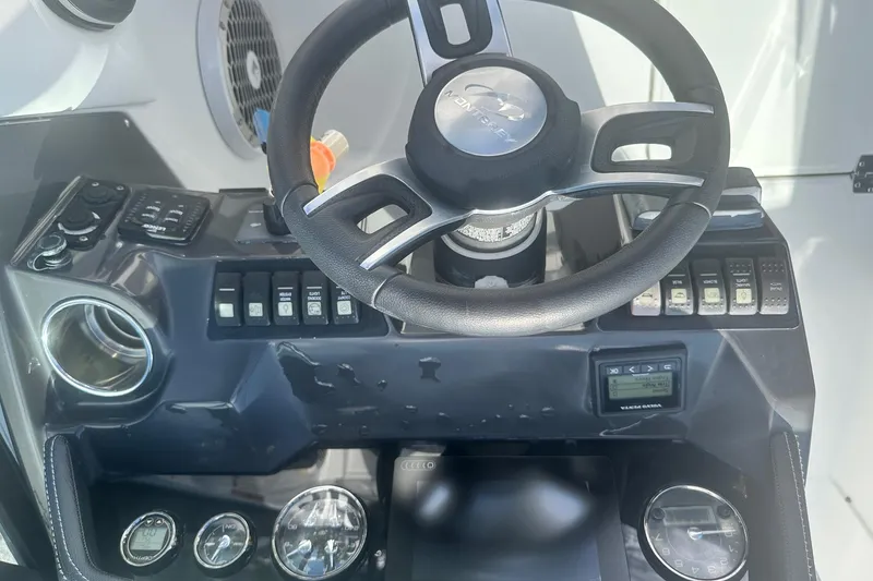 Slide: The Image of Steering wheel and dashboard of a 2020 Monterey M4 boat, featuring various controls and gauges. - 28