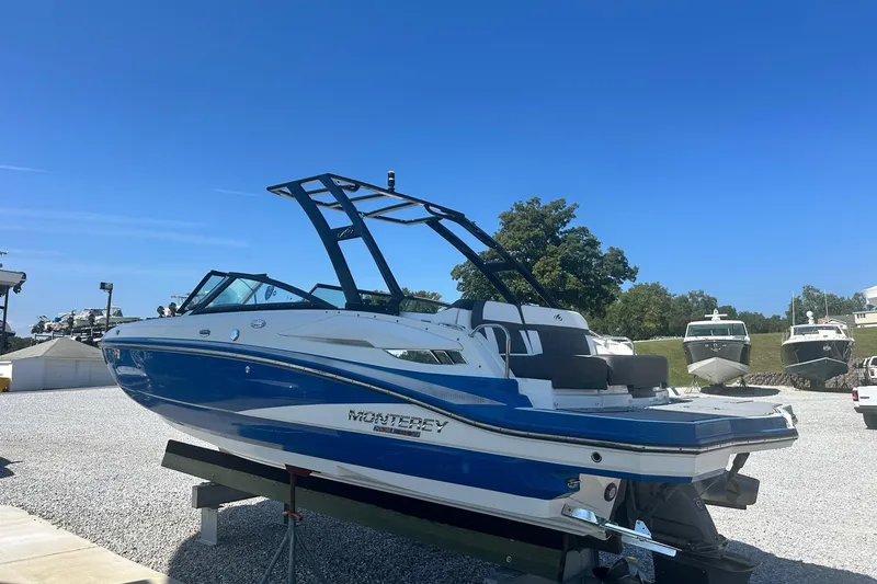 Slide: The Image of 2020 Monterey M4 boat in blue and white, displayed outdoors on a sunny day. - 3