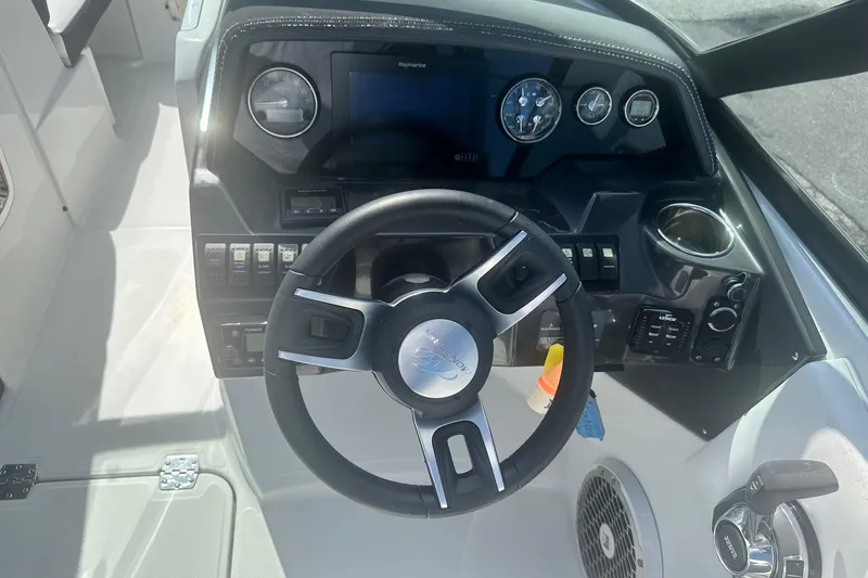 Slide: The Image of Steering wheel and dashboard of a 2020 Monterey M4 boat, featuring modern controls. - 30