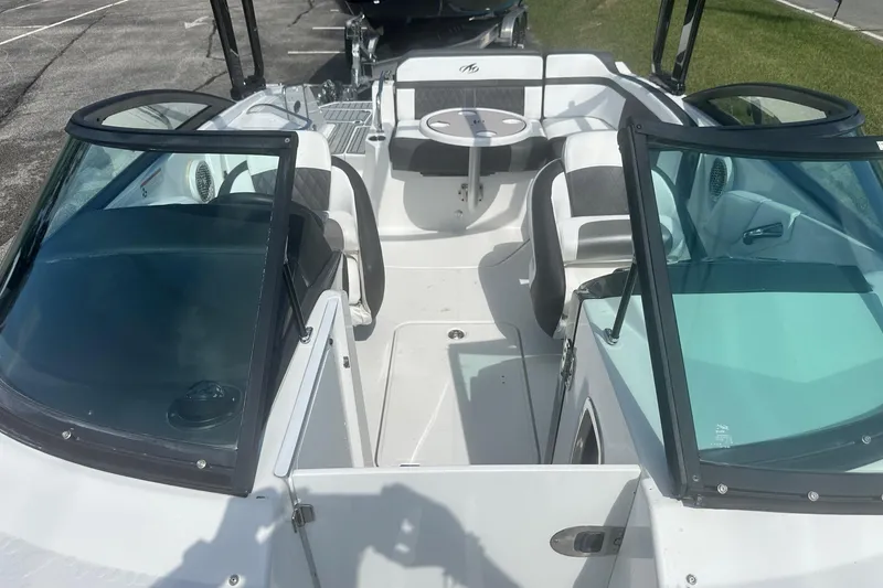 Slide: The Image of 2020 Monterey M4 boat interior with seating and table, parked on pavement. - 36