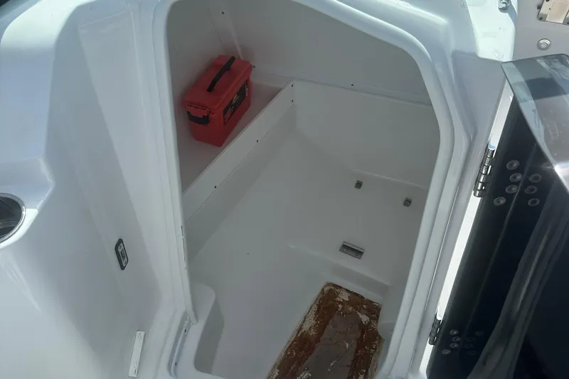 Slide: The Image of 2020 Monterey M4 boat storage compartment with red toolbox inside. - 43