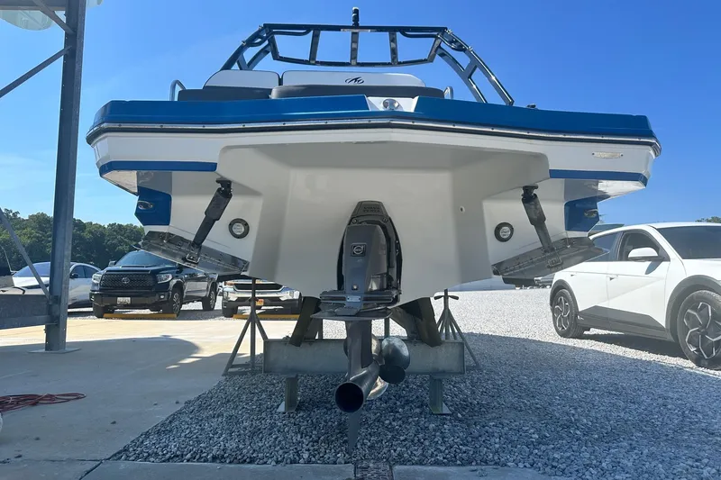 Slide: The Image of 2020 Monterey M4 boat on trailer, parked near vehicles under clear blue sky. - 5