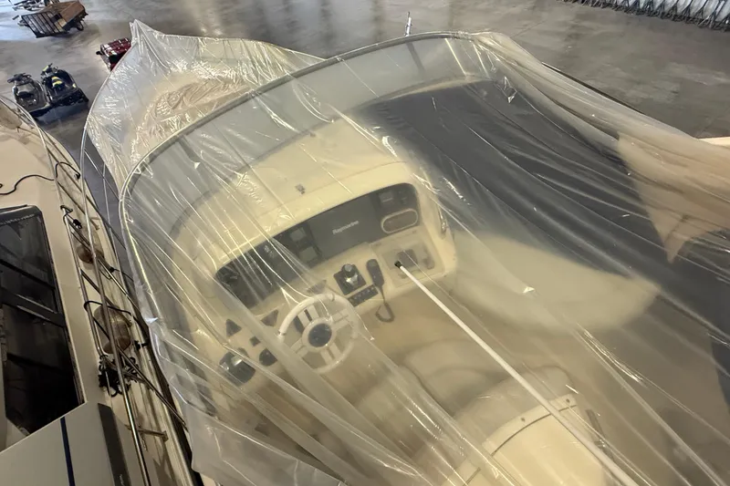 Slide: The Image of 2008 Azimut 55 EVOLUTION yacht helm covered in protective plastic wrap. - 10