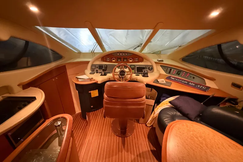 Slide: The Image of Luxurious helm of 2008 Azimut 55 EVOLUTION yacht with leather seating and wood accents. - 23