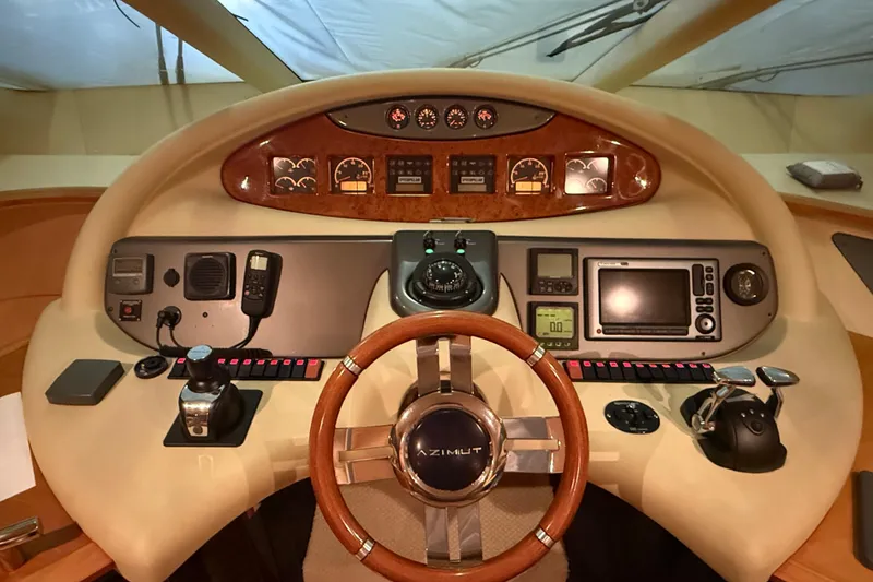 Slide: The Image of Cockpit of 2008 Azimut 55 EVOLUTION yacht with steering wheel and navigation controls. - 24