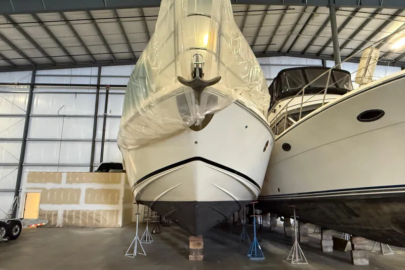Slide: The Image of 2008 Azimut 55 EVOLUTION yacht stored indoors, covered, alongside another boat. - 3