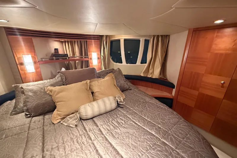 Slide: The Image of Luxurious bedroom interior of 2008 Azimut 55 EVOLUTION yacht with elegant bedding and wood accents. - 30