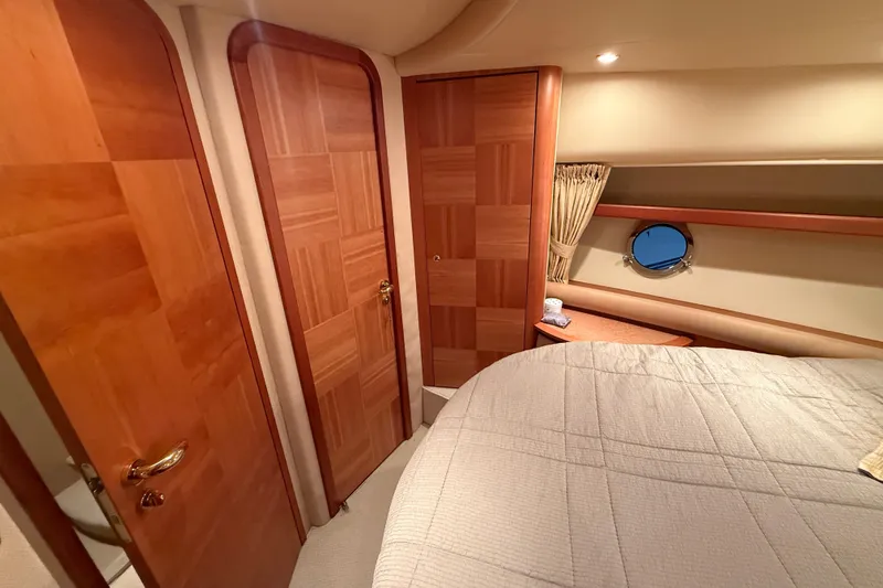 Slide: The Image of Luxurious cabin interior of 2008 Azimut 55 EVOLUTION yacht with wooden doors and porthole. - 38
