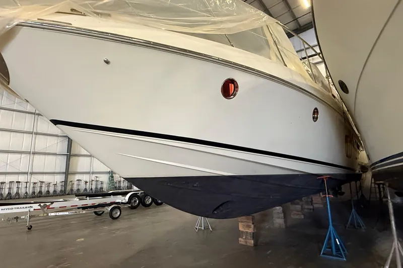 Slide: The Image of 2008 Azimut 55 EVOLUTION yacht in storage, supported by stands in a warehouse. - 4