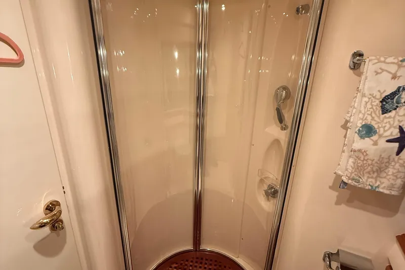 Slide: The Image of Shower area in 2008 Azimut 55 EVOLUTION yacht with glass doors and nautical-themed towel. - 42