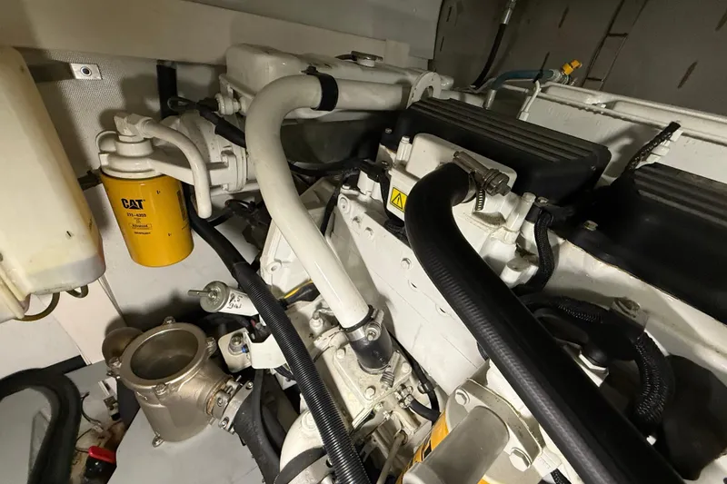 Slide: The Image of Engine room of 2008 Azimut 55 EVOLUTION yacht, featuring CAT filter and hoses. - 50