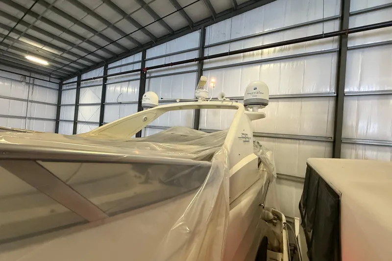 Slide: The Image of 2008 Azimut 55 EVOLUTION yacht stored indoors, partially covered with protective plastic. - 6