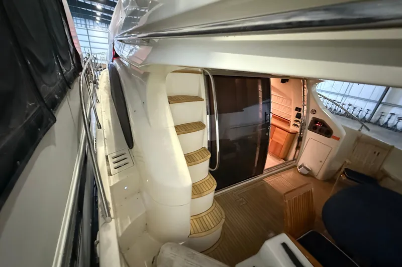 Slide: The Image of 2008 Azimut 55 EVOLUTION yacht interior with spiral staircase and seating area. - 8