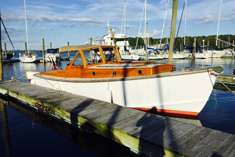 The Image of Custom 2005 Gannon & Benjamin boat docked at a marina with sailboats in the background. - 0