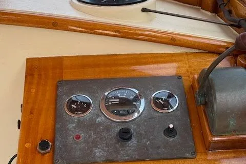 Slide: The Image of Control panel of a 2005 Custom Gannon & Benjamin boat with wooden finish. - 11