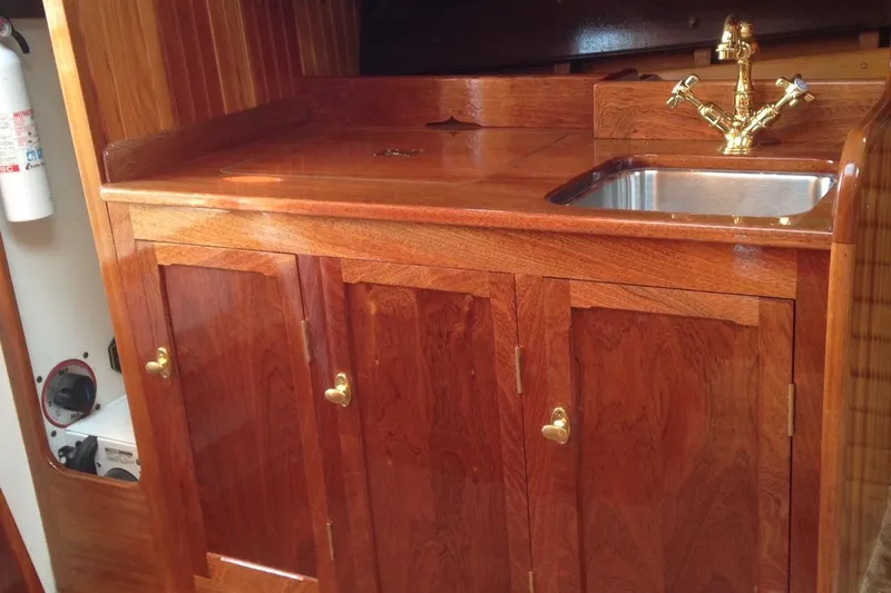Slide: The Image of Wooden boat galley with brass faucet, stainless steel sink, and polished cabinetry, Custom Gannon & Benjamin 2005. - 14