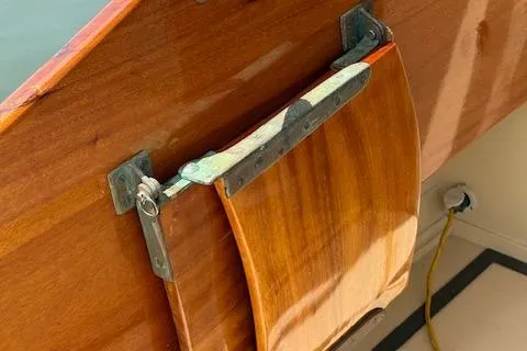 Slide: The Image of Wooden rudder of a 2005 Custom Gannon & Benjamin boat with metal fittings. - 16