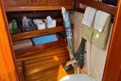 Slide: The Image of Wooden boat interior with storage shelves, towels, and a toilet; Gannon & Benjamin, 2005. - 17