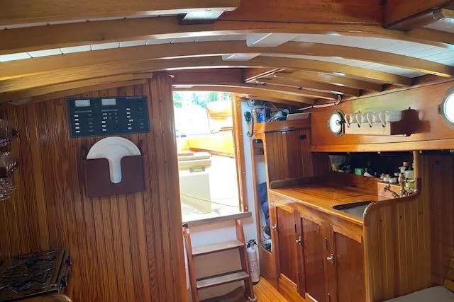 Slide: The Image of Interior of a 2005 Custom Gannon & Benjamin boat with wooden cabinetry and nautical decor. - 20