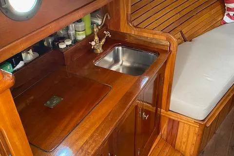 Slide: The Image of Custom Gannon & Benjamin 2005 boat interior with wooden cabinetry and compact sink. - 22