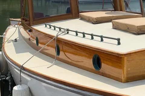 Slide: The Image of Custom Gannon & Benjamin 2005 boat with wooden deck and portholes, docked in marina. - 3