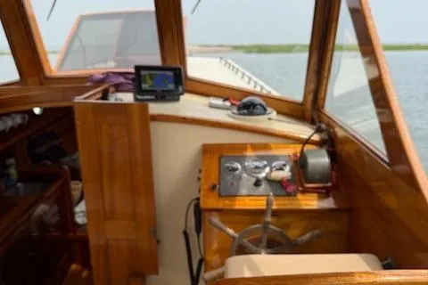 Slide: The Image of Wooden boat interior with steering wheel, navigation equipment, and control panel, Custom Gannon & Benjamin, 2005. - 9