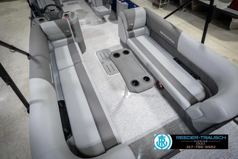 Slide: The Image of 2026 Bennington 25 SSR pontoon boat interior with gray seating and cup holders. - 13