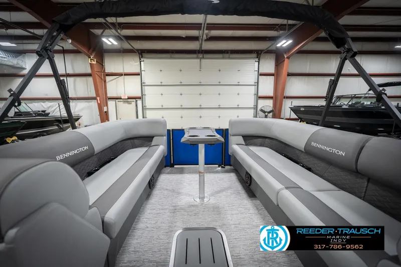 Slide: The Image of 2026 Bennington 25 SSR pontoon boat interior with gray seating in a showroom. - 21
