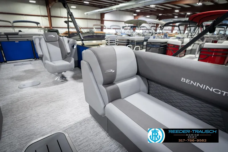 Slide: The Image of 2026 Bennington 25 SSR pontoon boat interior with gray seating in showroom. - 24